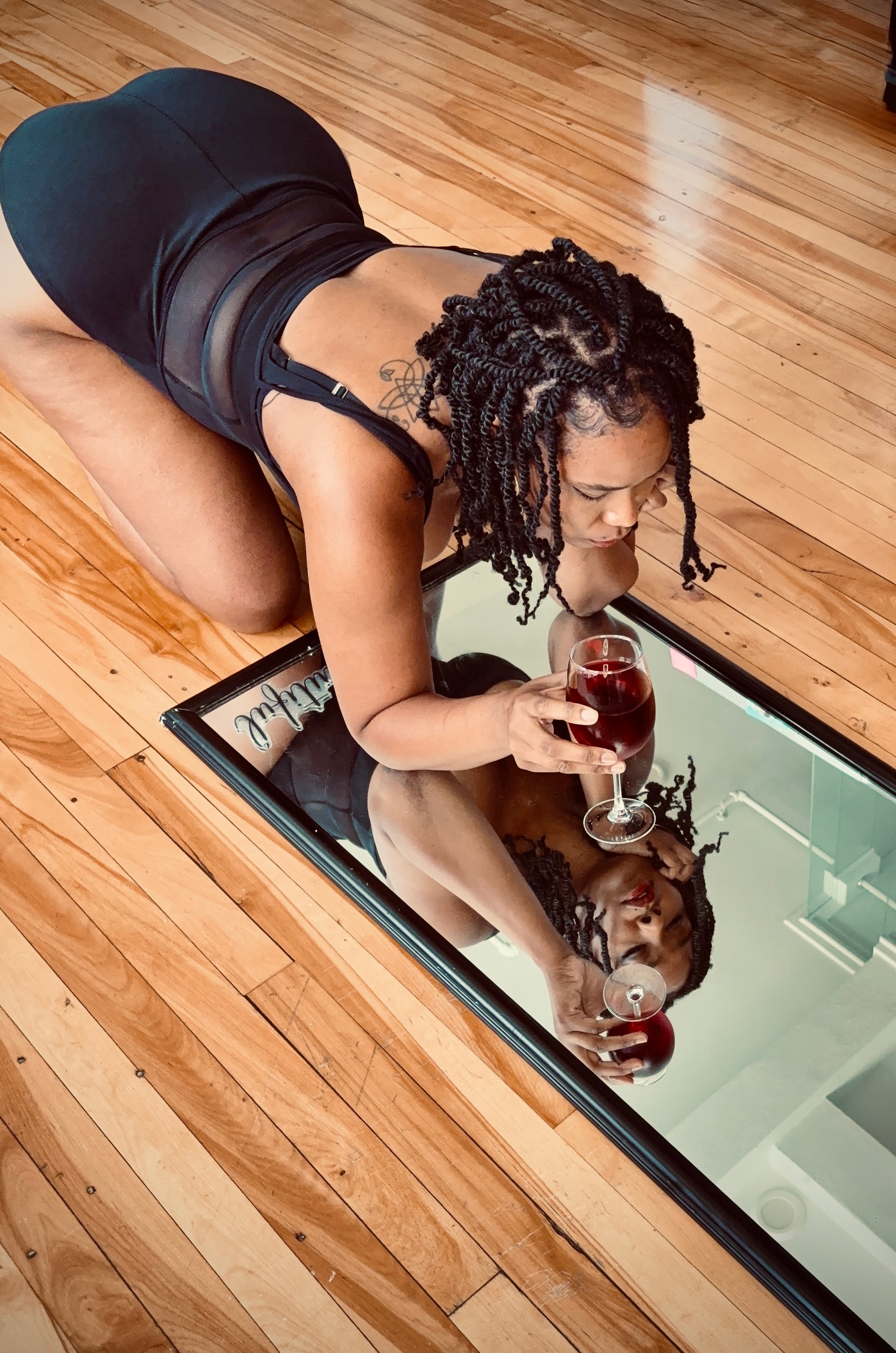 Aleis Noir reflected on a mirror floor